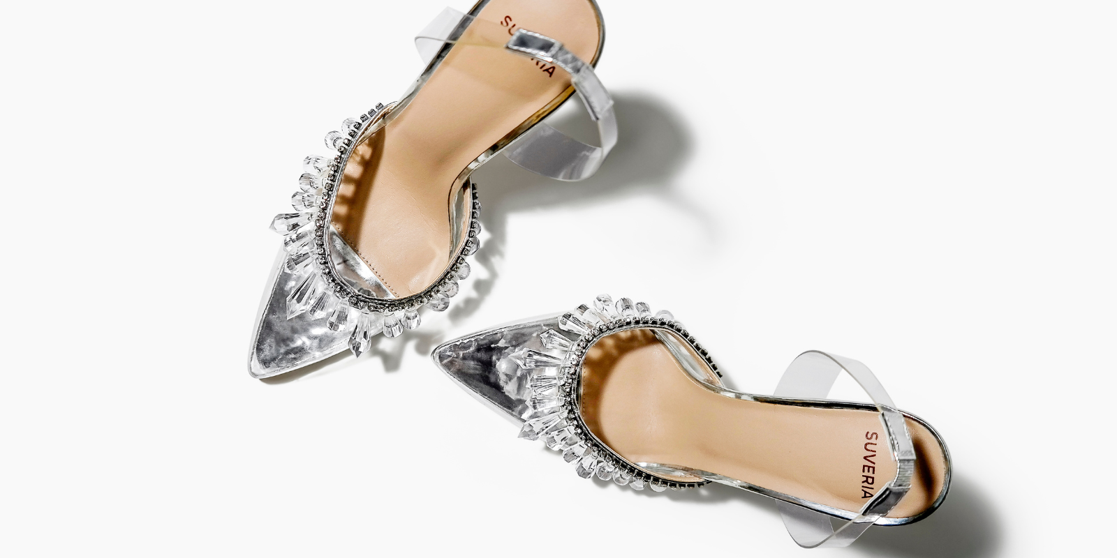 pair of women's heeled slingbacks. Clear with crystals. Silver insole.